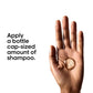 Hand holding a small amount of shampoo with text on a white background