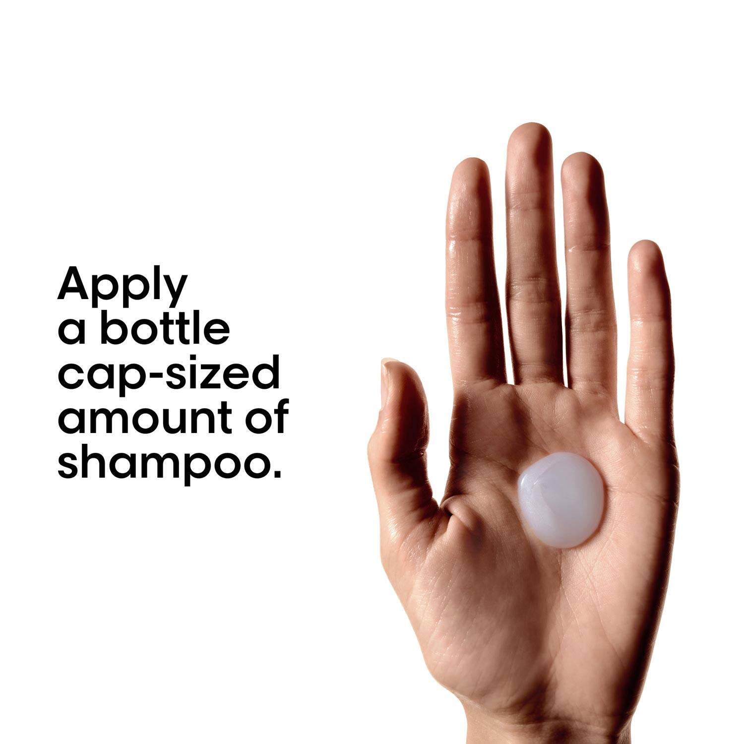 Hand with a small amount of shampoo on the palm against a white background